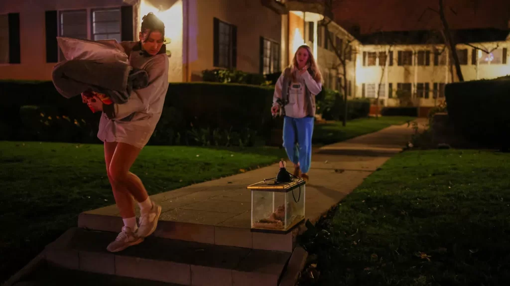 Residents leave following an evacuation order, as a wildfire burns in the Pacific Palisades neighborhood of west Los Angeles, in Santa Monica, California, U.S., January 7, 2025.